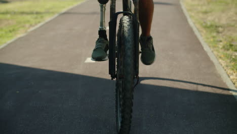 Vista-Frontal-De-Un-Hombre-Irreconocible-Con-Discapacidad-Conduciendo-Una-Bicicleta.